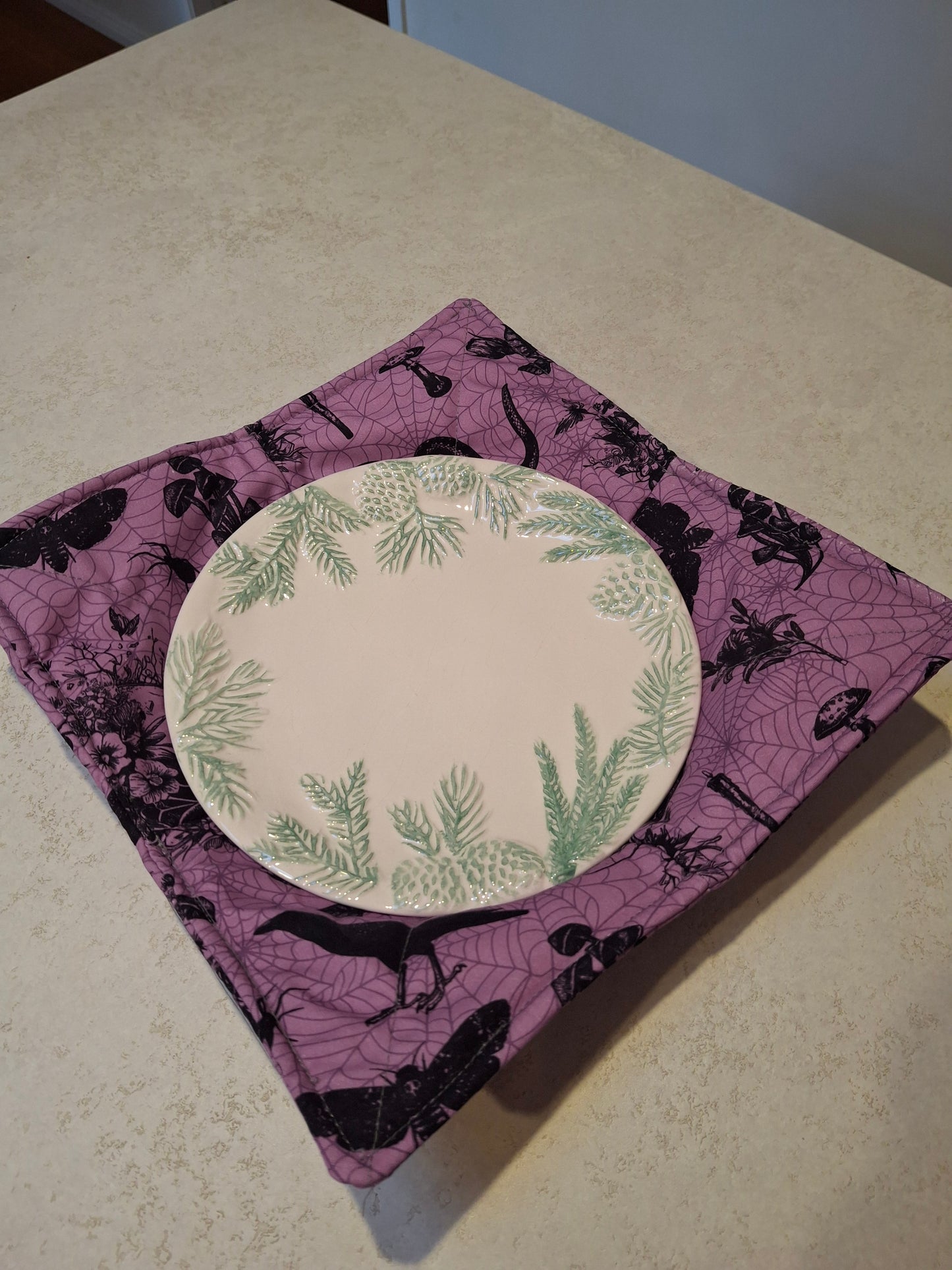 Purple spooky plate cosy