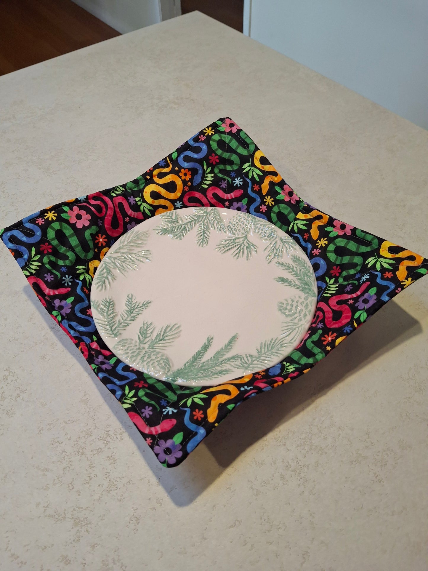 Colourful snakes plate cosy