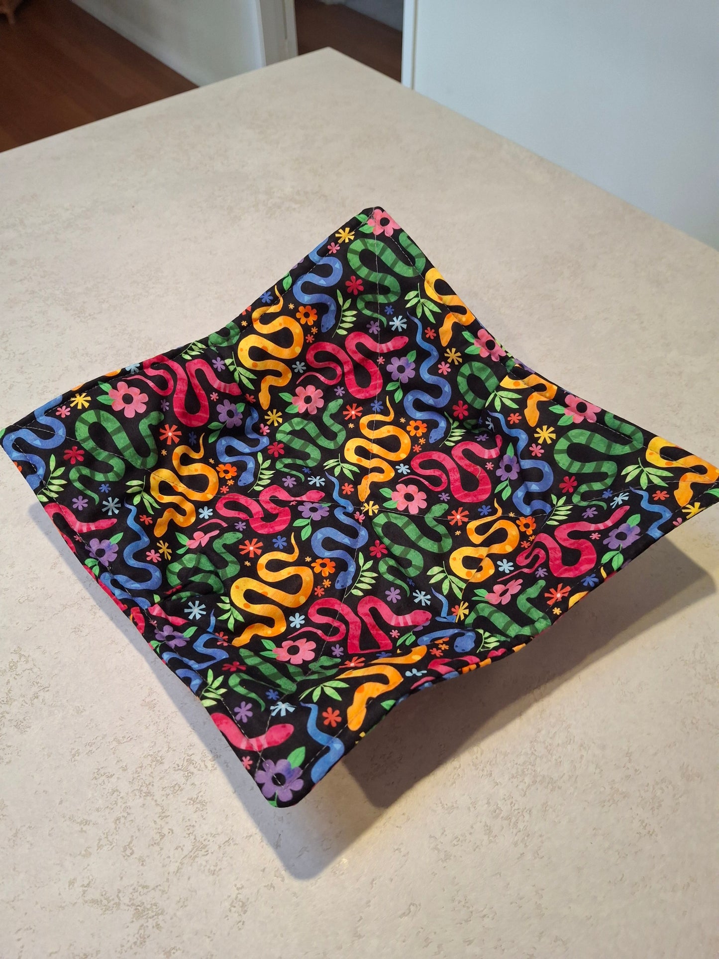 Colourful snakes plate cosy